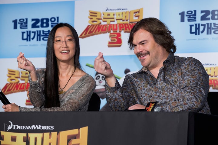 "Kung Fu Panda 3" director Jennifer Yuh shows actor Jack Black how to form a proper finger heart at a 2016 press event.