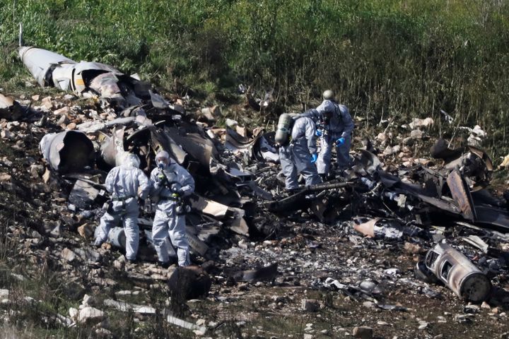Israeli forces examine the remains of the downed F-16 in Harduf, Israel