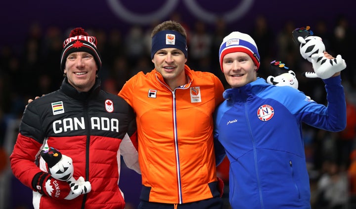 Silver medalist Ted-Jan Bloemen of Canada (left) gold medalist Sven Kramer of the Netherlands (center) and bronze medalist Sverre Lunde Pedersen of Norway celebrate their finishes in the men's 5000m speed skating competition.