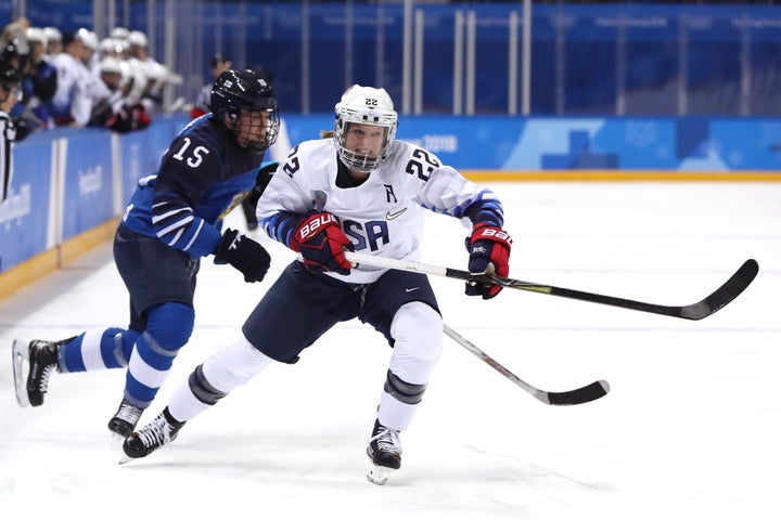 Kacey Bellamy, right, of the United States collides with Finland's Minnamari Tuominen.