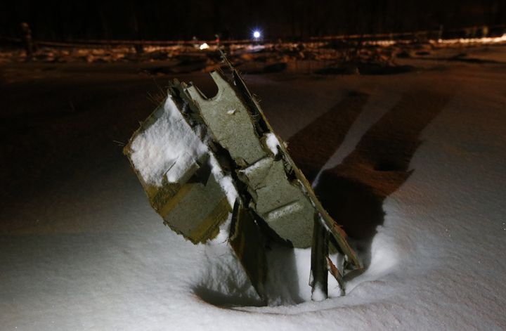 A part of the Saratov Airlines Antonov AN-148 plane embedded in the snow 