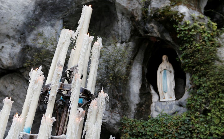 Lit candles are seen near the entrance to the Grotto of Massabielle in Lourdes, France, on Nov. 4, 2016.