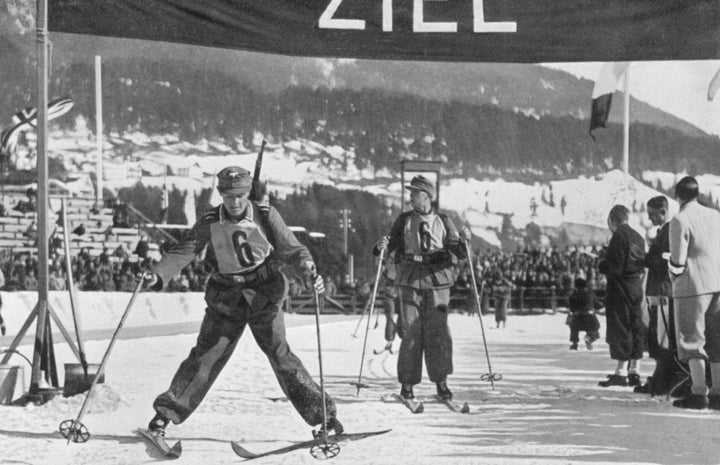 The German military ski patrol team crossing the finish line to take fifth place during the 1936 Winter Olympics in Garm