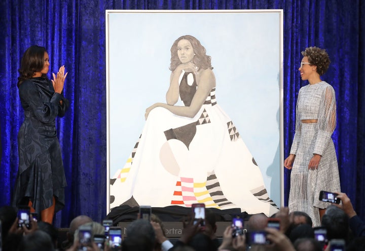 Former U.S. first lady Michelle Obama and artist Amy Sherald unveil Obama's portrait during a ceremony at the Smithsonian's National Portrait Gallery on Feb. 12, 2018.