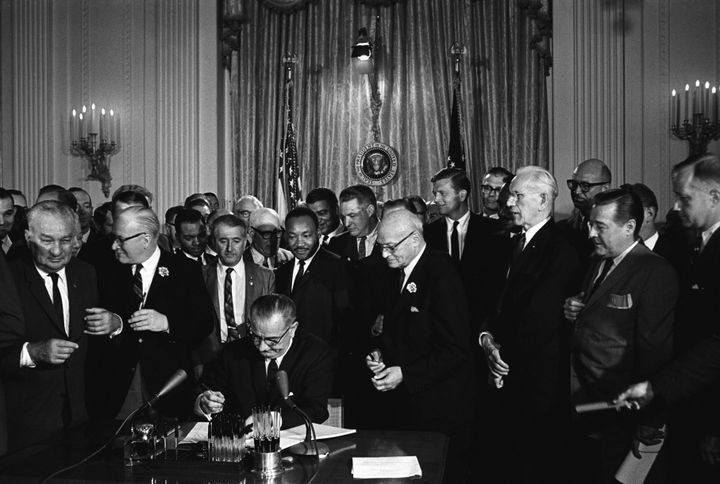 Then-President Lyndon B. Johnson signs the 1964 Civil Rights Act, which established a Justice Department office to provide confidential services to ease tensions in communities facing racial and other conflicts. The Trump administration's budget proposal would eliminate the office.