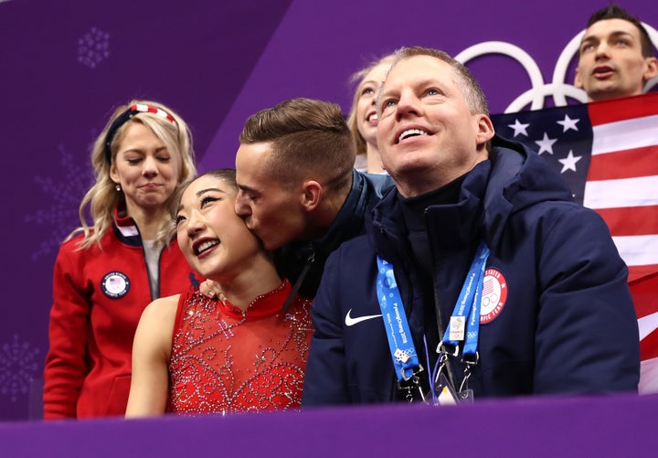 Mirai Nagasu is kissed on the cheek by teammate Adam Rippon.