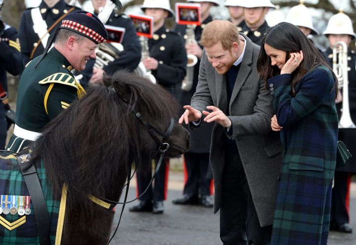 Prince Harry and Meghan Markle meet Pony Major Mark Wilkinson and regimental mascot Cruachan IV during a walkabout on the esplanade at Edinburgh Castle