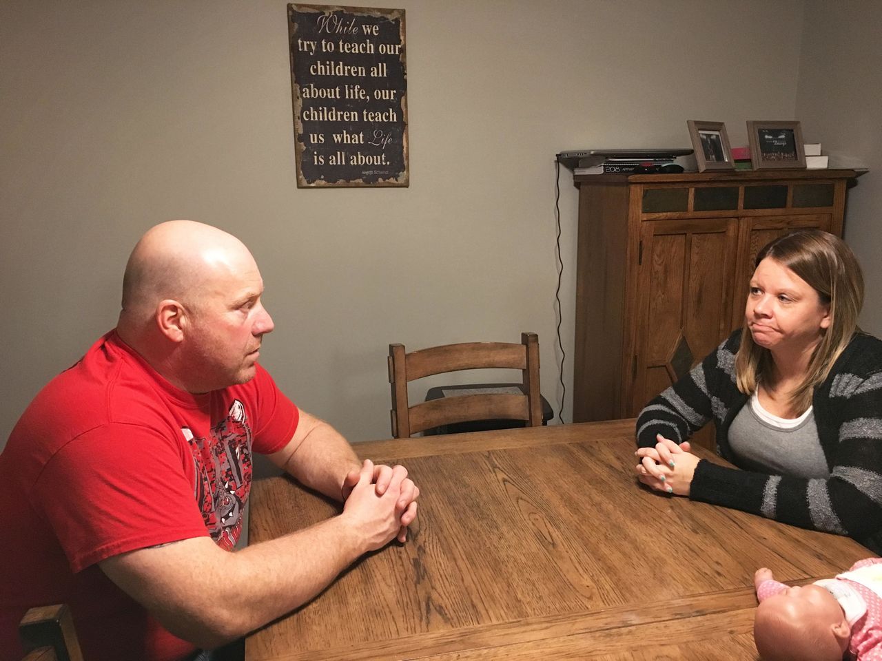 Tracy and Danielle Lammers, sitting in their dining room two weeks after learning Medi-Share considered Danielle's cancer a pre-existing condition and rejected payment for treatment. Medi-Share later reversed its decision, following their appeal.