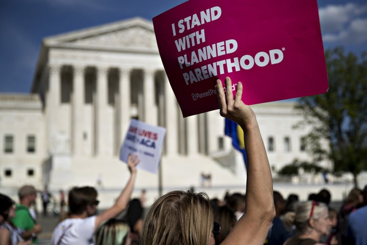 A demonstrator holds a sign that reads "I Stand With Planned Parenthood" near the U.S. Supreme Court in Washington on June 28, 2017.