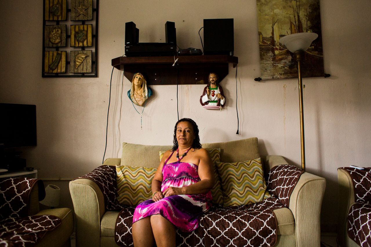 Carmen Bonilla Ramos sits at her home in the mountains of Rincón, Puerto Rico