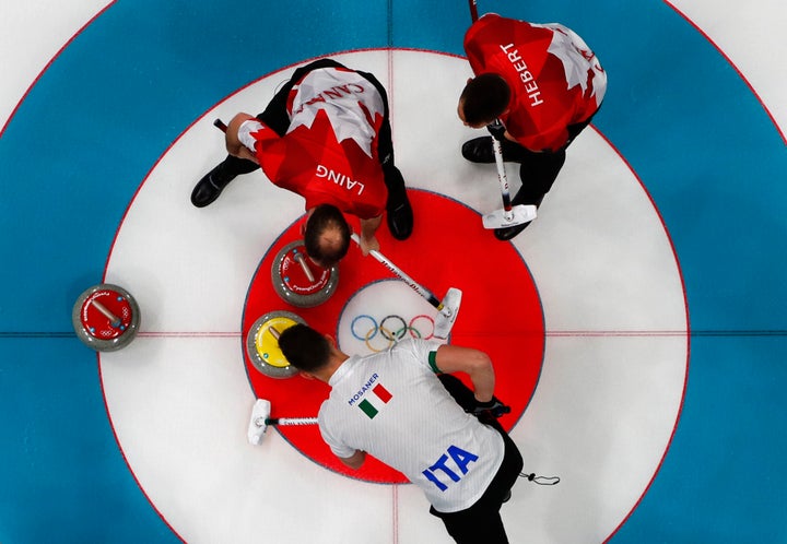 Brent Laing and teammate Ben Hebert in the Canada vs. Italy in curling competition on Wednesday.