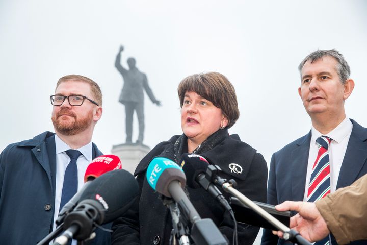 DUP leader Arlene Foster, with party colleagues Simon Hamilton and Edwin Poots (right), speaks with media at Carson Statue