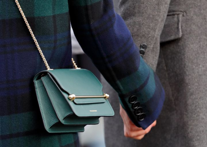 Meghan Markle was wearing a new season Burberry tartan coat, and Veronica Beard trousers, with her Bottle Green East/West Mini Strathberry bag.