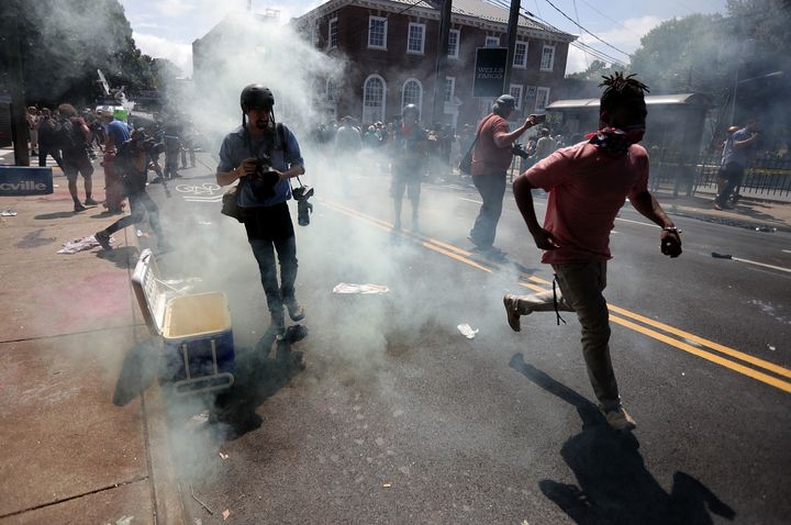 Protesters and journalists pull back after tear gas was used during the Unite the Right rally on Aug. 12, 2017, in Charlottesville, Virginia.