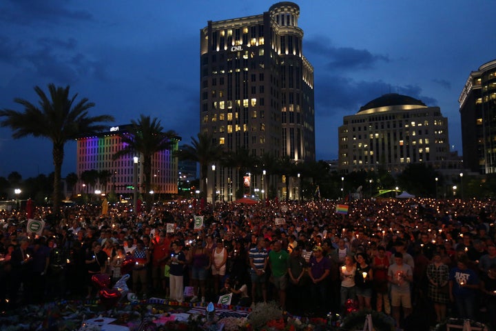 People take part in a candlelight memorial service the day after the mass shooting at the Pulse nightclub in Orlando, Florida, in June of 2016.