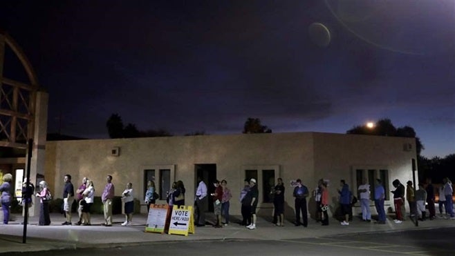 Voters in Phoenix, seen here waiting for polls to open at dawn in November 2016, had to wait as long as four hours to vote du