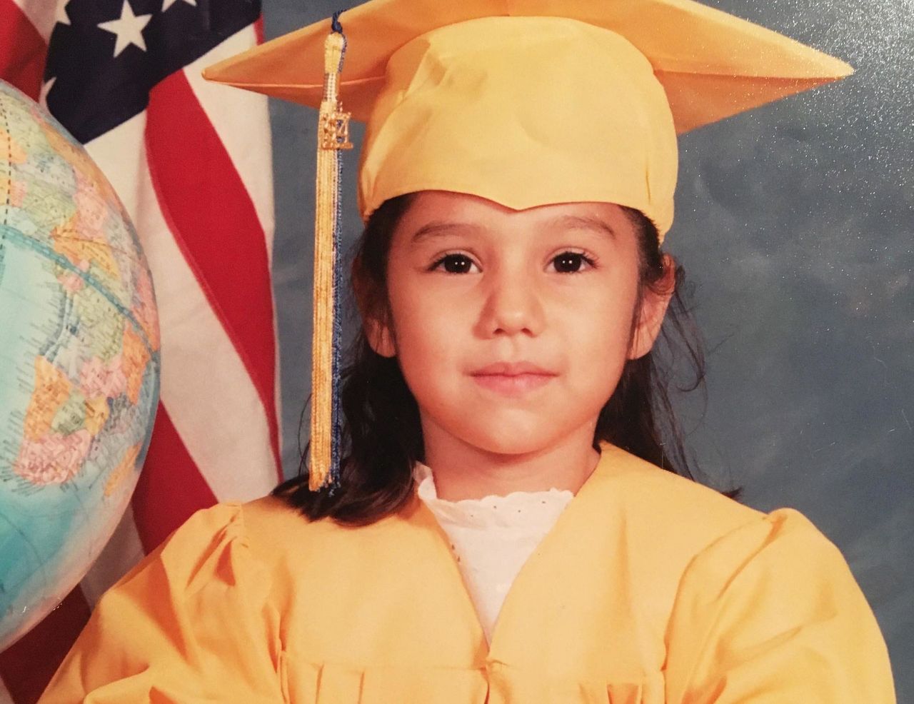 Norma, age 5, poses for her kindergarten graduation photo.