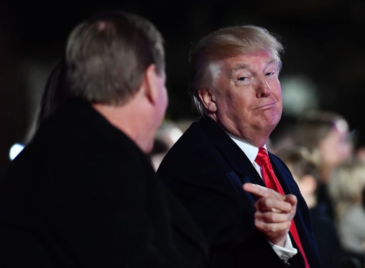 President Donald Trump gestures toward Secretary of the Interior Ryan Zinke during the annual national Christmas tree lighting ceremony near the White House on Nov. 30.