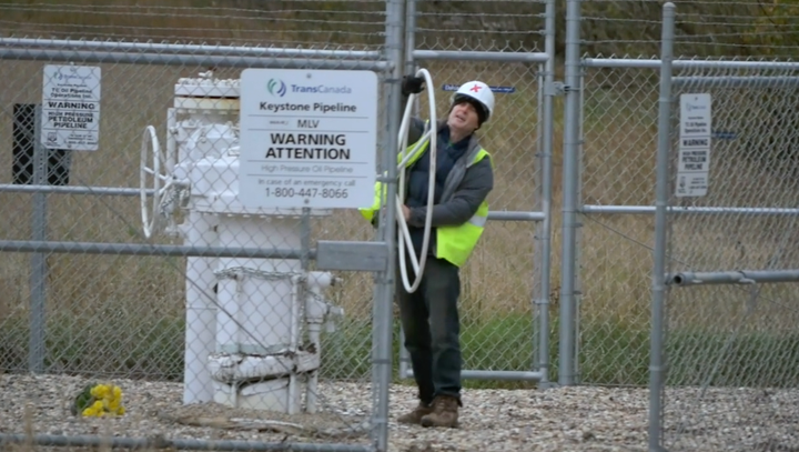 A screenshot of Michael Foster turning the valve on the Keystone Pipeline. 