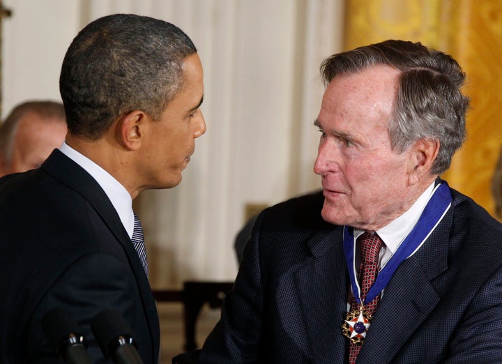 U.S. President Barack Obama congratulates Medal of Freedom recipient and former U.S. President George H.W. Bush during a ceremony to present the awards, Feb. 15, 2011.