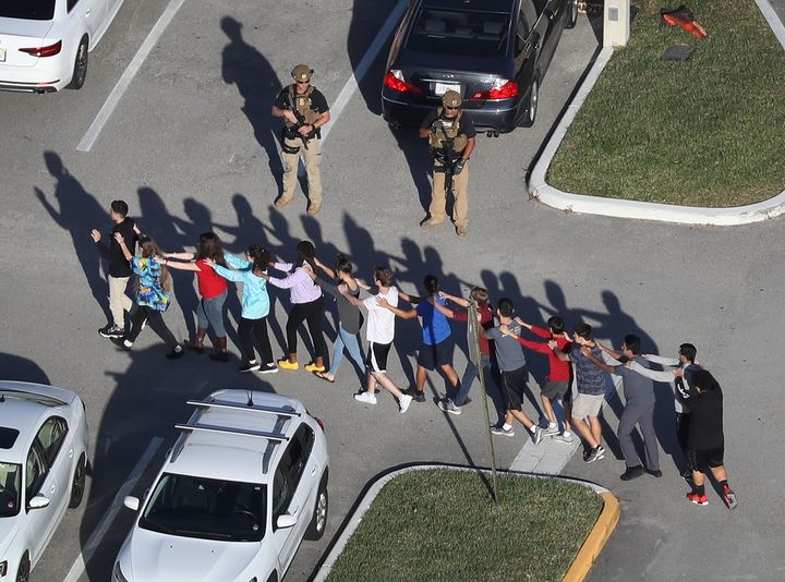 Students evacuate Marjory Stoneman Douglas High School, in Parkland, Florida, after a shooting there killed numerous people on Feb. 14, 2018.