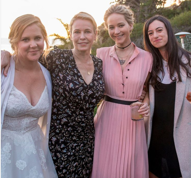 Jennifer Lawrence (second from right) had a few buttons undone at the wedding of friend Amy Schumer (left).