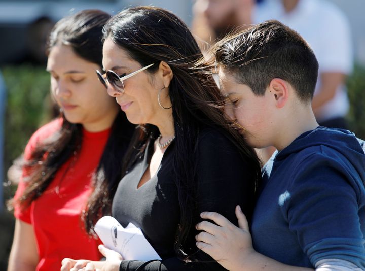 People attend a community prayer vigil for victims of the shooting at Marjory Stoneman Douglas High School in Parkland, Florida.