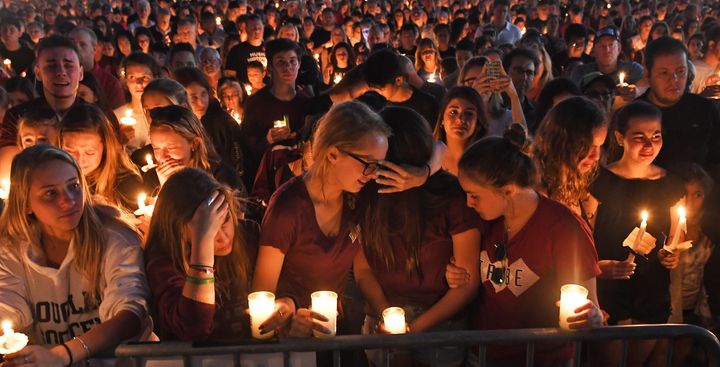 Mourners gather for a candlelight vigil for the victims of Wednesday's school shooting in Parkland, Florida.