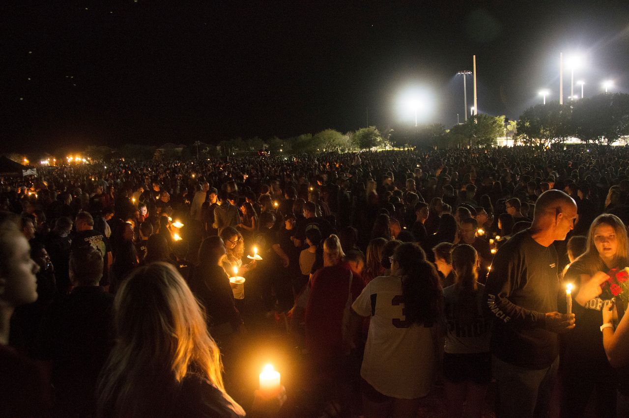 Thousands of community members gather to mourn those who died in Wednesday's school shooting in Parkland, Florida.