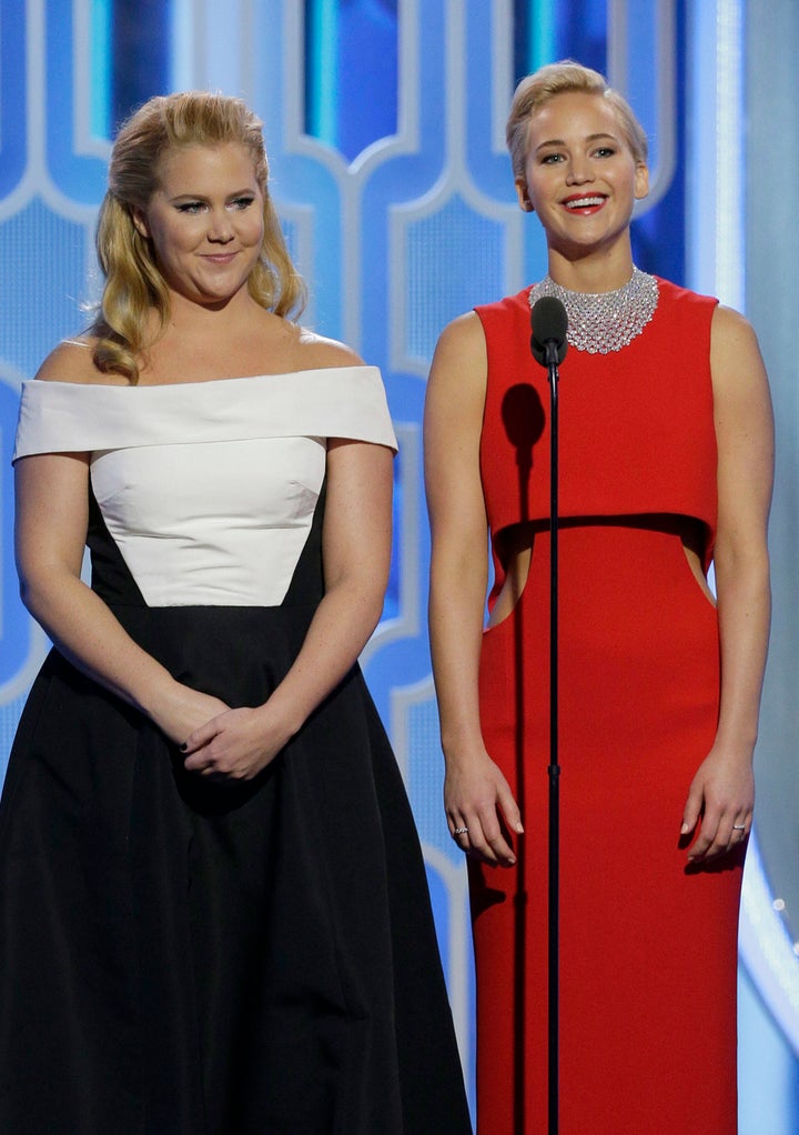 Amy Schumer and Jennifer Lawrence speak onstage during the 73rd Annual Golden Globe Awards.