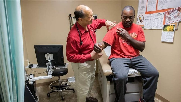 A doctor examines a Medicaid patient at the Heart City Health Center in Elkhart, Indiana. Indiana and other states are seizin
