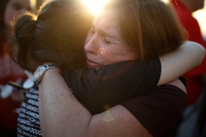 A shared embrace during the candlelight vigil for victims of the mass shooting at Marjory Stoneman Douglas High School in Parkland, Florida.