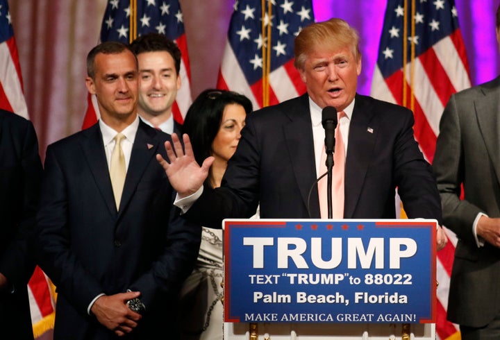 Trump speaks with campaign manager Corey Lewandowski at his side in 2016.