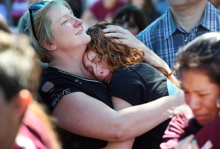 Tonya Kramer embraces her daughter, Alyssa, 16, during a community prayer vigil at Parkridge Church in Coral Springs, Florida, on Thursday.