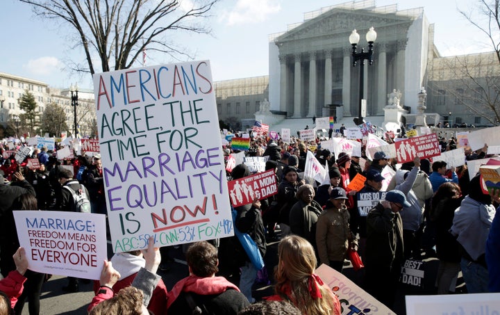 Demonstrators gather in front of the Supreme Court on March 26, 2013, before the court struck down a key provision of the so-called Defense of Marriage Act.