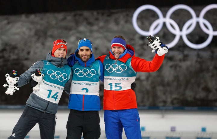 From left: Silver medalist Simon Schempp of Germany, gold medalist Martin Fourcade of France, and bronze medalist Emil Hegle Svendsen of Norway celebrate during Sunday's victory ceremony.