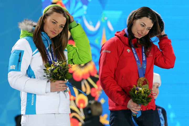 Gold medalists Switzerland's Dominique Gisin (R) and Slovenia's Tina Maze pose on the podium during the Women's Alpine Skiing Downhill Medal Ceremony at the 2014 Winter Olympics in Sochi.