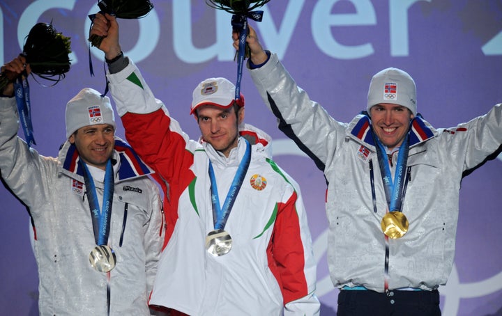 Gold medalist Norway’s Emil Hegle Svendsen (R) and silver medalists Norway’s Ole Einar Bjoerndalen (L) and Belaru