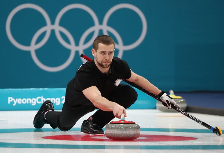 Krushelnitsky delivers a stone in the mixed doubles curling bronze medal match.