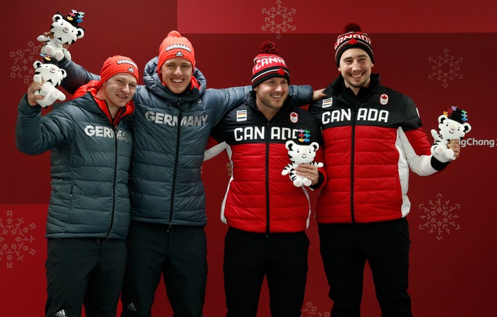 Francesco Friedrich (far left) and Thorsten Margis of Germany shared gold medals on Monday with Alexander Kopacz (far right) and Justin Kripps of Canada in the two-man bobsled race at the Winter Olympics.