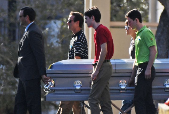 Pallbearers walk the casket of Scott Beigel, a teacher at Marjory Stoneman Douglas High School, following a service at Temple Beth El in Boca Raton, Fla., on Sunday.