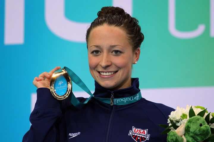 Ariana Kukors holds up her gold medal after winning the women's 100-meter individual medley on day three of the World Swimming Championships on Dec. 17, 2010.