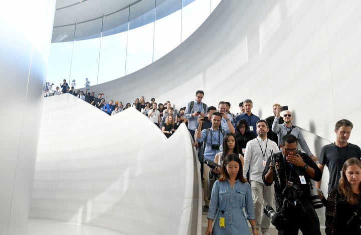 Members of the media enter the Steve Jobs Theater at Apple's new headquarters ahead of new product announcements in Cupertino