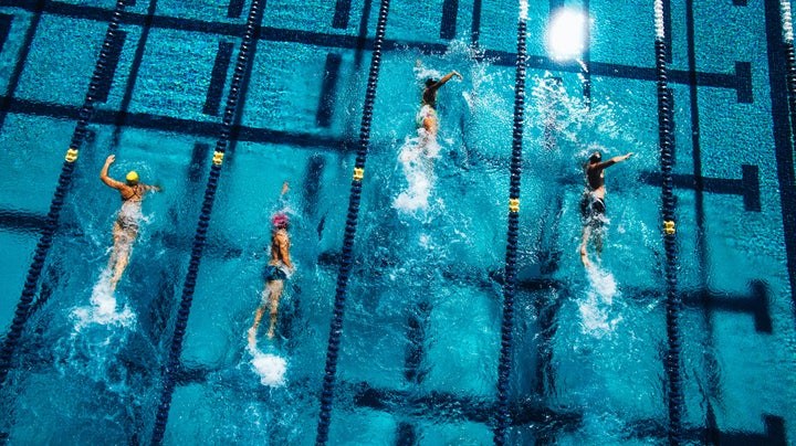 Stock photo of swimmers in pool.
