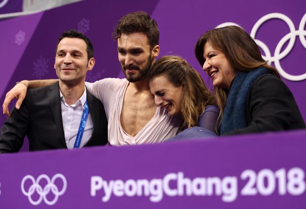 Gabriella Papadakis and Guillaume Cizeron, center, react after competing in the Figure Skating Ice Dance Free Dance on February 20, 2018