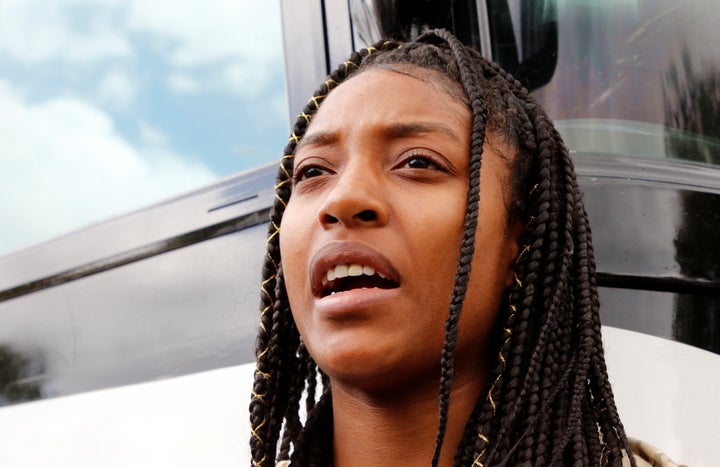 Tyra Hemans, 19, a senior at Marjory Stoneman Douglas High School, speaks before boarding buses with other students to meet with legislators.