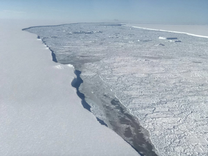 The edge of Larsen C Ice Shelf with the western edge of iceberg A68 in the distance. 
