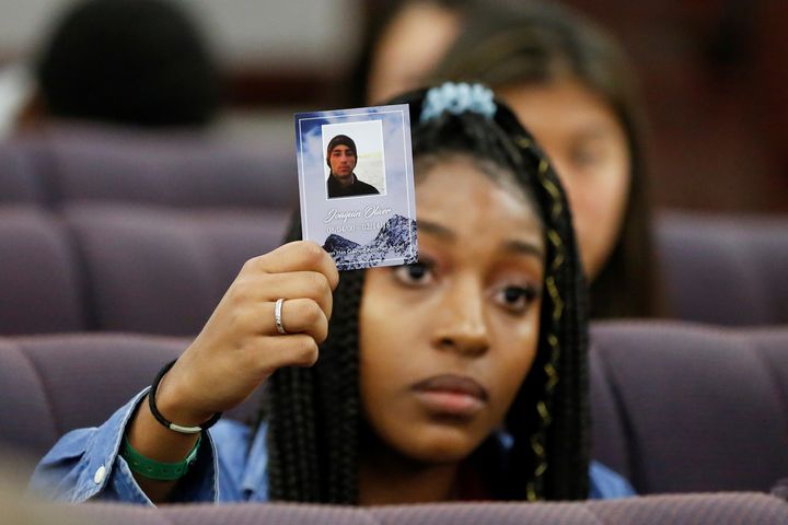 Tyra Hemans, a senior from Marjory Stoneman Douglas High School, holds a photo of her friend Joaquin Oliver, who died during last week's mass shooting on her campus, as she and other MSD students speak with the leadership of the Florida Senate at the Capitol in Tallahassee.