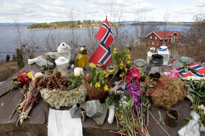 Norway's national flags, flowers and candles are arranged at a memorial site northwest of Oslo that commemorates the 69 peopl