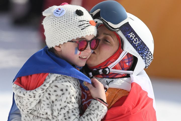 France's Marie Martinod celebrates with her daughter after the women's ski halfpipe final.